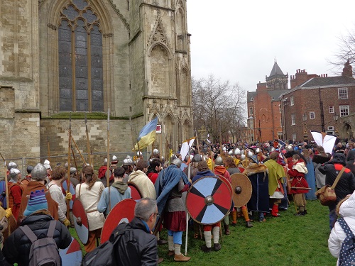 Viking warriors line up outside York Minster, getting ready to parade.