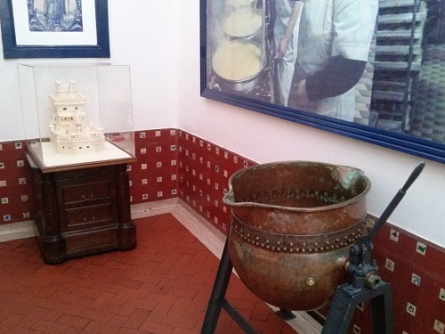 Displays of old photographs and tart making instruments at Pastéis de Belém