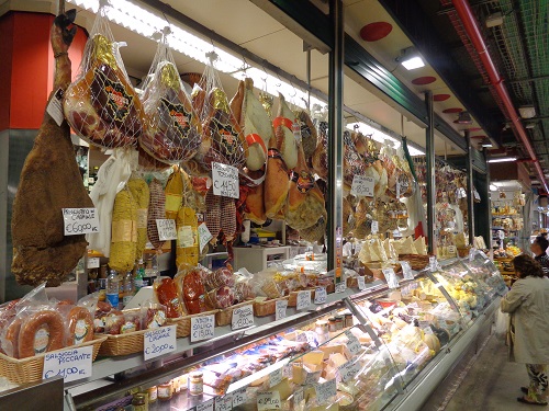 Rows of prosciutto and cheese on display for sale at the 19th Century Mercato Centrale 